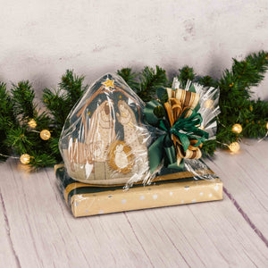 a one pound box of assorted chocolates is topped with a weighted plush pillow that features a nativity scene on one side and read 'happy birthday Jesus' on the other side