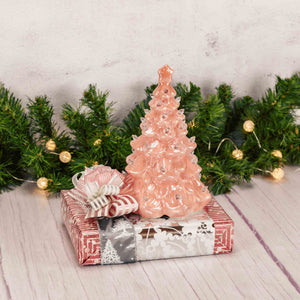 an 8 inch nostalgic pink lighted ceramic tree is placed on top of a box that is filled with wonderful treats and candies