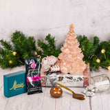 an 8 inch nostalgic pink lighted ceramic tree is placed on top of a box that is filled with wonderful treats and candies