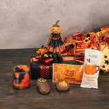 a resin pumpkin girl figurine sits atop a box full of spooky treats!