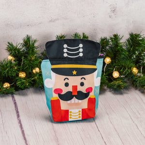 a zipper nutcracker pouch bag is filled with festive treats for kids to enjoy