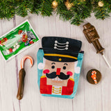 a zipper nutcracker pouch bag is filled with festive treats for kids to enjoy