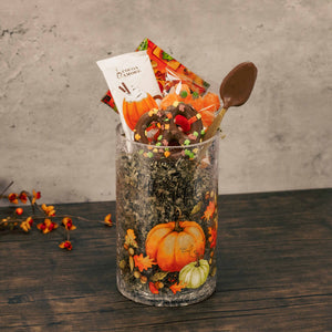 a crinkle glass cylinder that reads 'so very thankful' with a battery light strip and is filled with festive treats