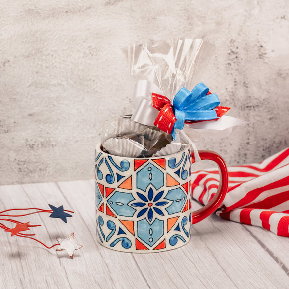 Usher in the patriotic holidays this summer with this fun red, white and blue geometric design mug that is filled with a half pound of our decadent Assorted Milk Chocolates. Tied with a handmade bow, making a lovely gift for a friend, or even yourself! Mug is microwave and dishwasher safe.