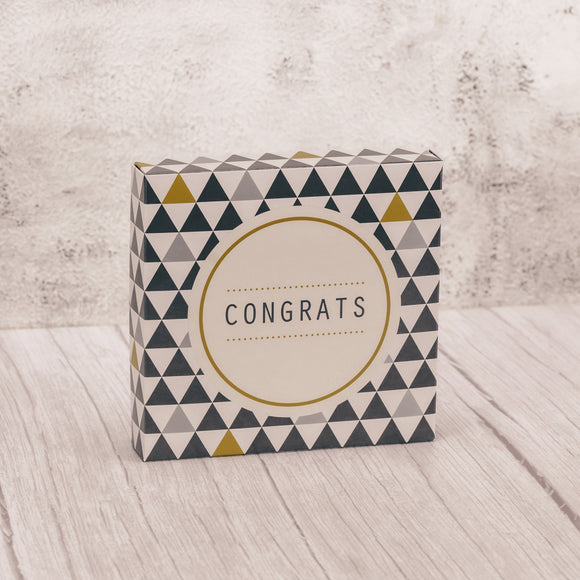 a half pound square box filled with assorted chocolates that reads 'congrats' on the lid