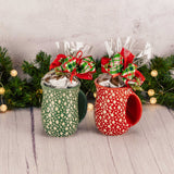 a hand warming mug is filled with over a half pound of assorted milk chocolates. Choose a red or green mug
