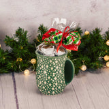 a hand warming mug is filled with over a half pound of assorted milk chocolates. Choose a red or green mug
