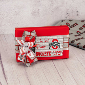 a half pound box of Buckeyes with a metal galvanized magnet that reads 'livin' that buckeye life' 