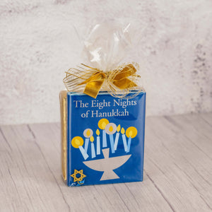 a sampler box of assorted chocolates with a book that explains more about the Hanukkah holiday and celebrations, 'The eight nights of Hanukkah'