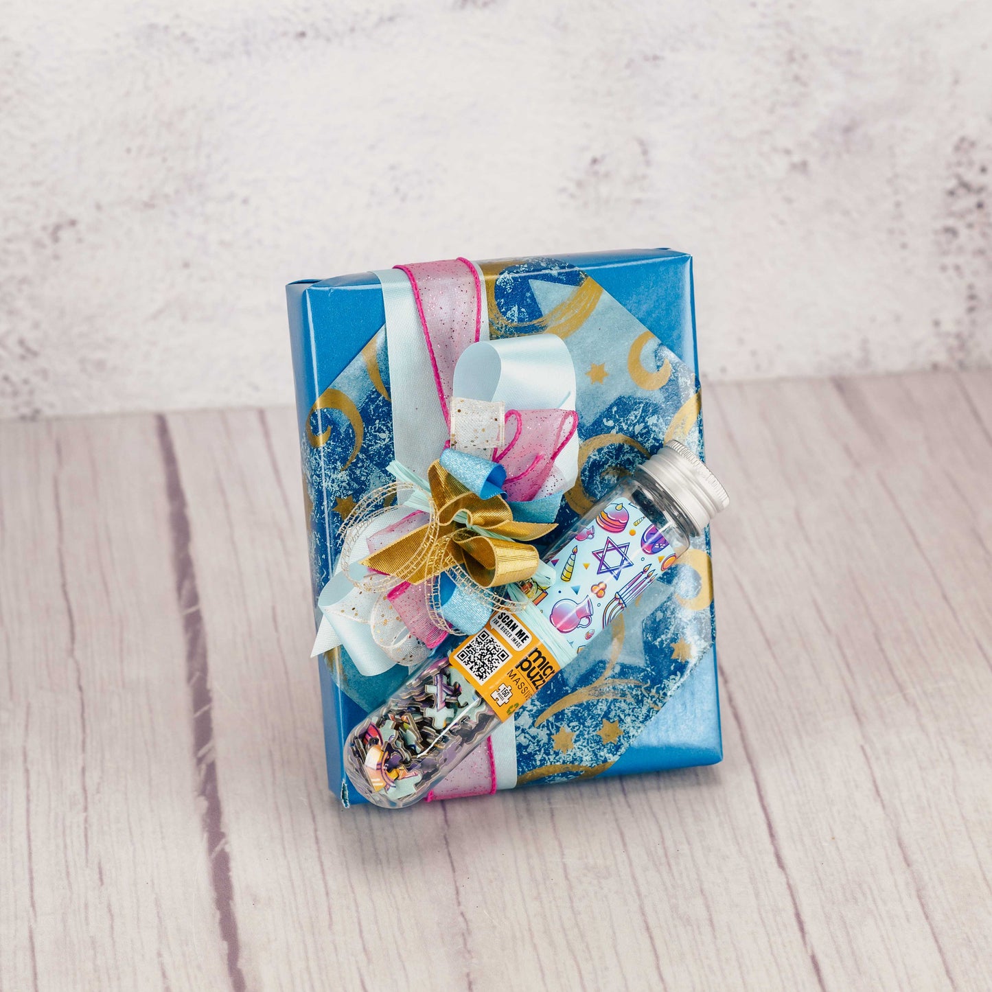 a half pound box of assorted milk and dark chocolates is wrapped and topped with a 150 mini piece menorah puzzle. 