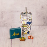 a tall tumbler cup with lid and straw featuring all things Michigan football is packaged with some sweet treats