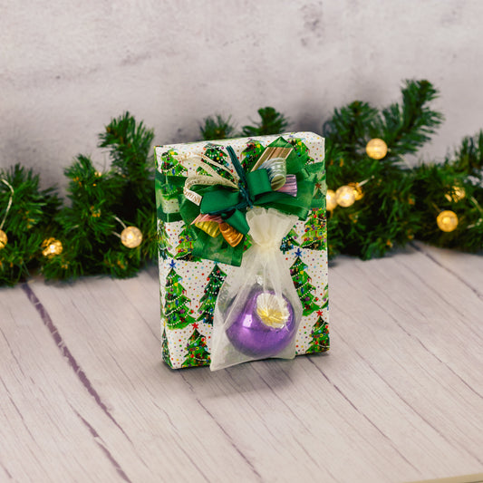 a half pound box of assorted chocolates wrapped in tree paper and topped with a colorful vintage round ornament