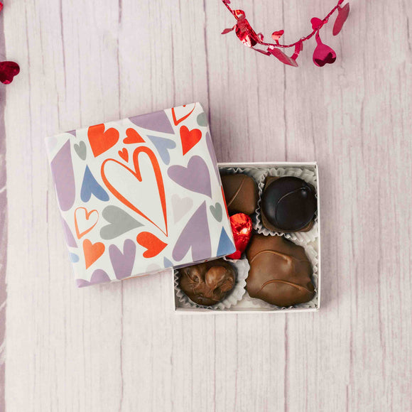 A heartfelt gesture friends and family will adore. A square box that reads with colorful doodle hearts all over it is packed with seven pieces of our premium Assorted Chocolates.