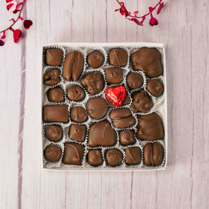 Treat your loved ones with heartwarming wishes with this one pound box with hearts doodled all over it and filled with a variety of stupendous Assorted Chocolates. Choose an assortment of all milk chocolates or a combination of milk and dark chocolates. 