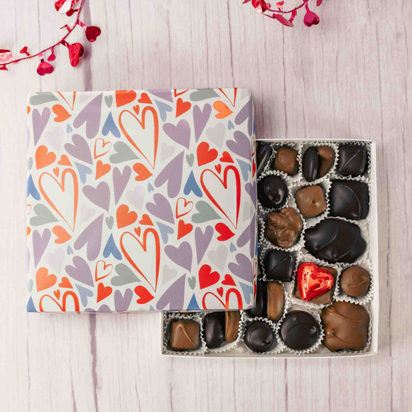 Treat your loved ones with heartwarming wishes with this one pound box with hearts doodled all over it and filled with a variety of stupendous Assorted Chocolates. Choose an assortment of all milk chocolates or a combination of milk and dark chocolates. 