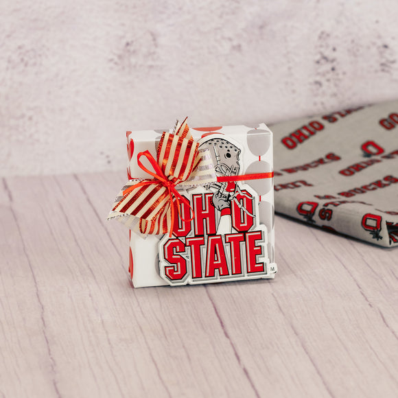 a sampler box of assorted chocolates wrapped and topped with an Ohio State helmet magnet