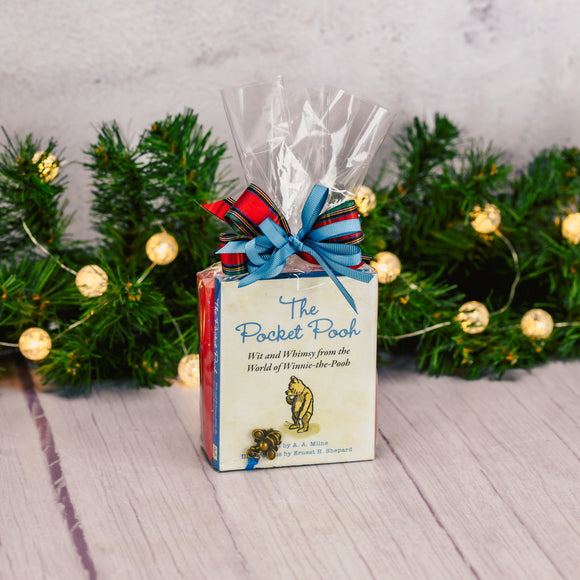 a pocked-sized book full of wit and whimsical portions of Winnie the Pooh is packaged with a sampler box of assorted chocolates