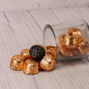 A half pound bag of decadent dark chocolate nugget pieces are wrapped in gold foil. Fill your candy dish with these for a wonderful treat! Approximately 25 in a half pound bag.
