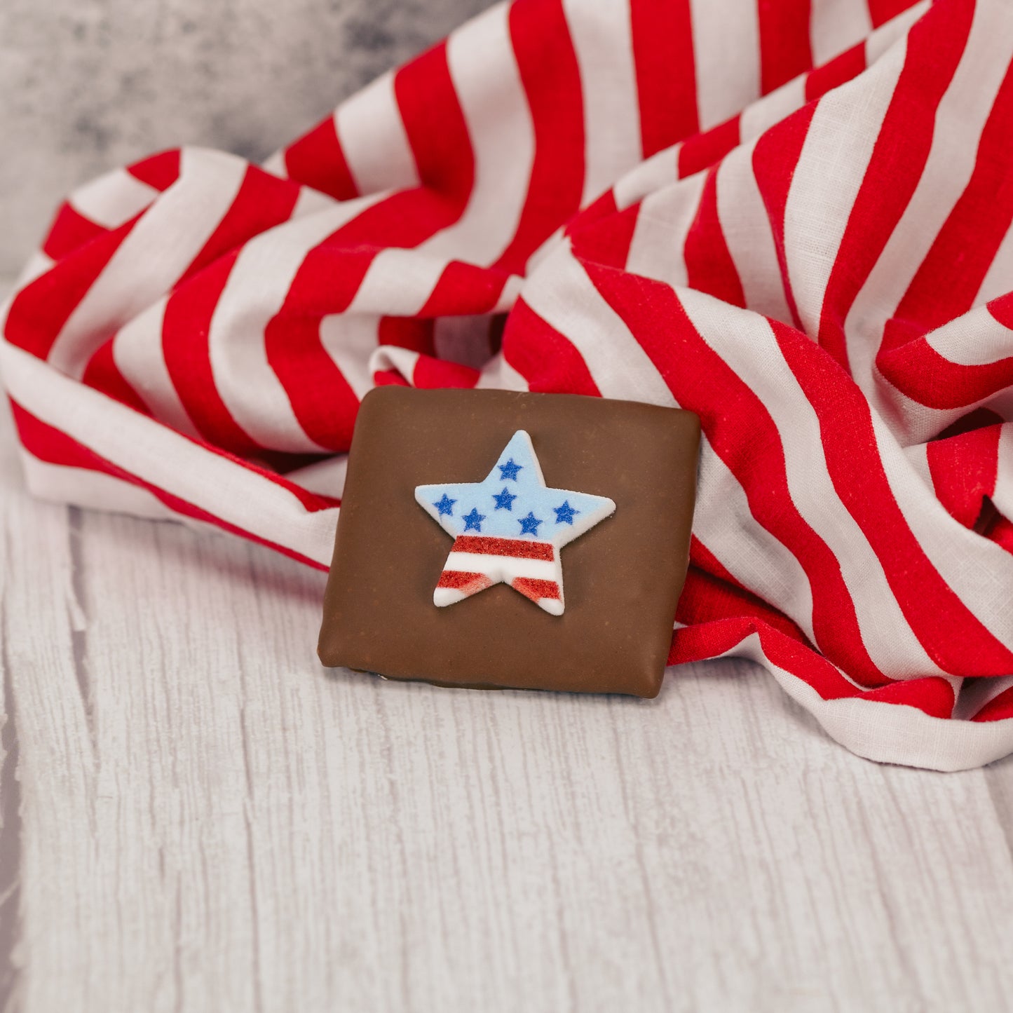 Our wonderful, silky-smooth milk chocolate turns a simple graham cracker into a decadent treat - even better with a patriotic sugar decoration on top! Packaged individually for a perfect sized snack. Assorted decoration styles.