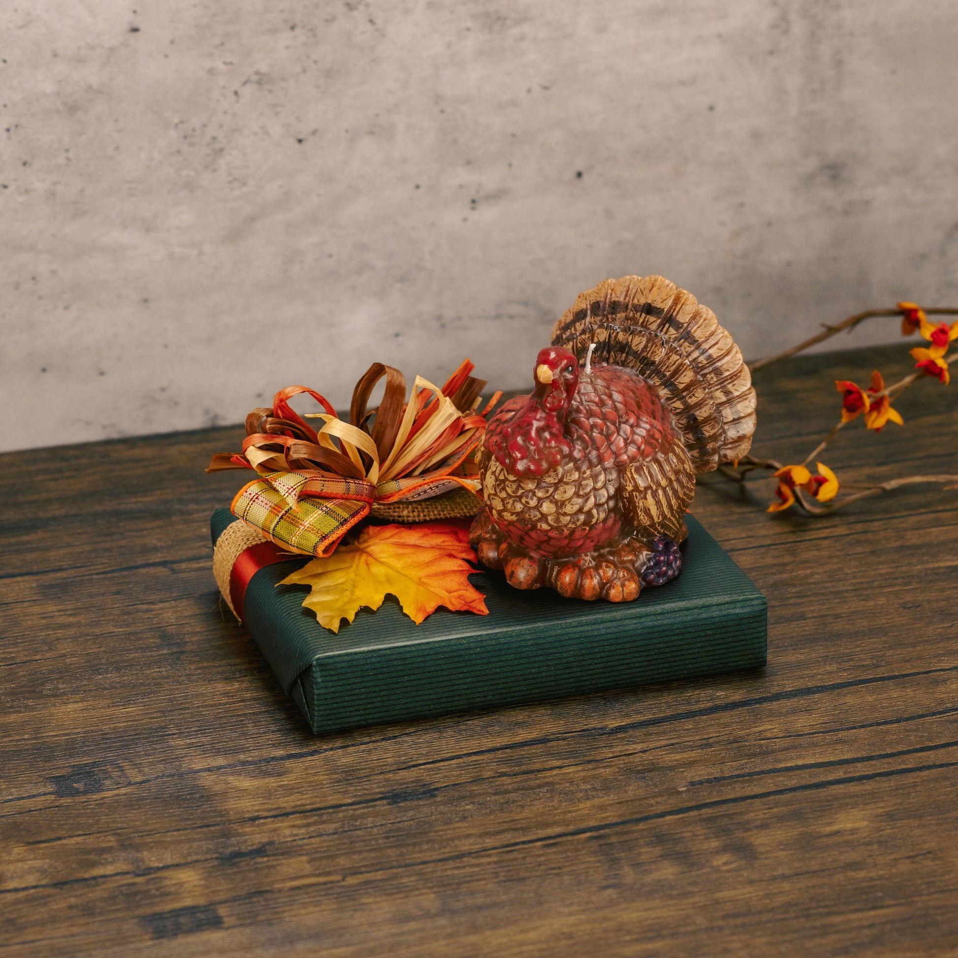 a half pound box of assorted chocolates is topped with a turkey candle