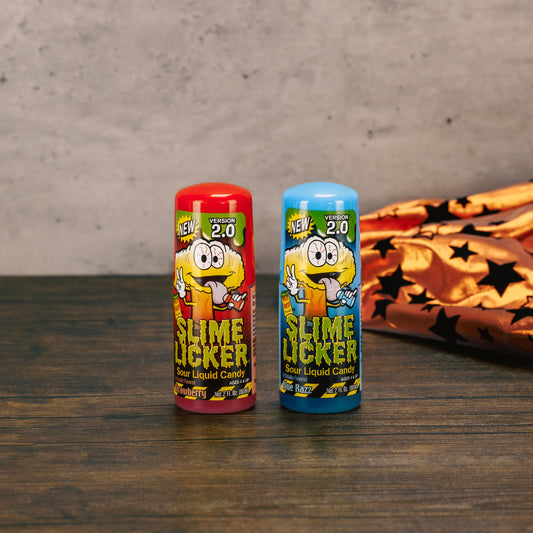 Slime Licker liquid sour candy in flavors Strawberry and Blue Razz, with a rolling ball top