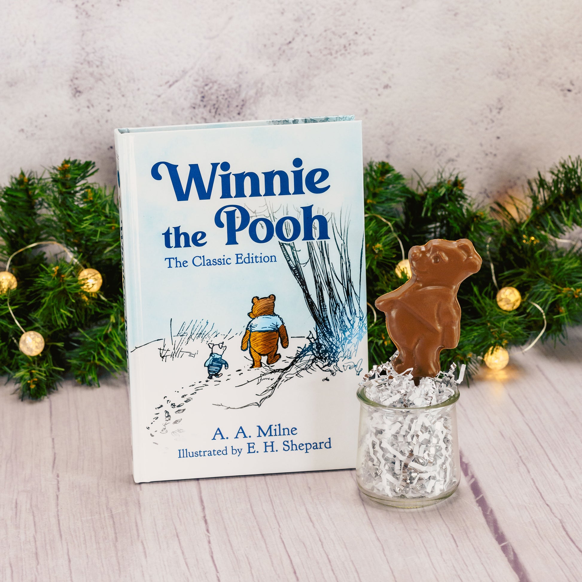 Winnie the Pooh classic edition book packaged with a chocolate pooh bear sucker