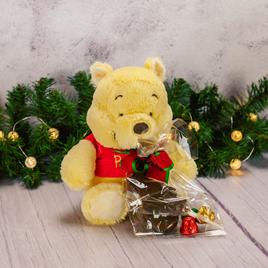 Winnie the Pooh plush with a bag of sweet treats