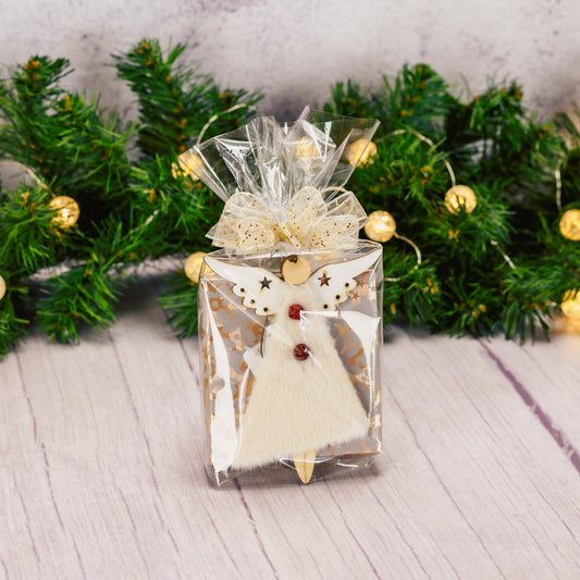 a fuzzy wooden angel ornament is packaged with a sampler box of assorted chocolates. assorted angel designs