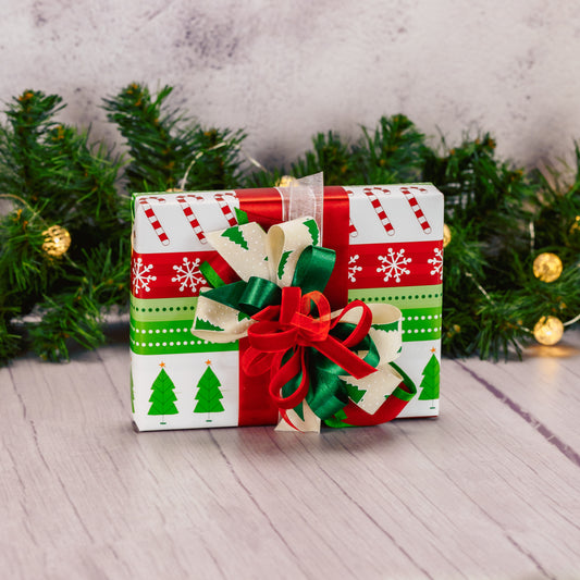 a half pound box of assorted chocolates is wrapped and bowed in red and greens.