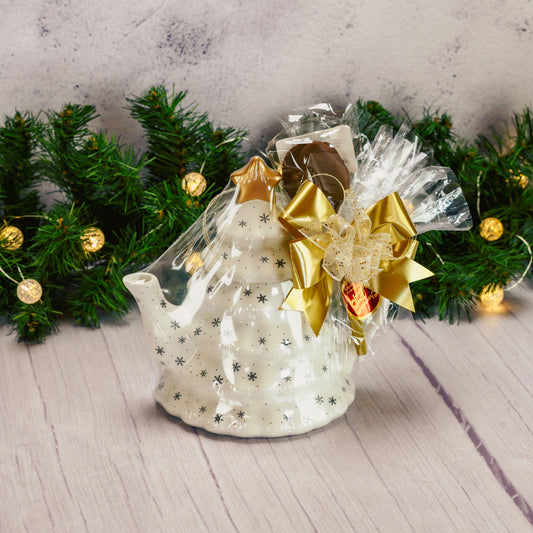 a white tree shaped teapot packaged with sweet treats