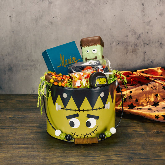 a large metal monster bucket is filled with sweet treats
