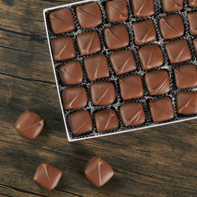A box full of one individual kind of chocolate candy.