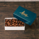 A one pound box of milk chocolate covered nuts like roasted cashews, pecans, and peanuts.