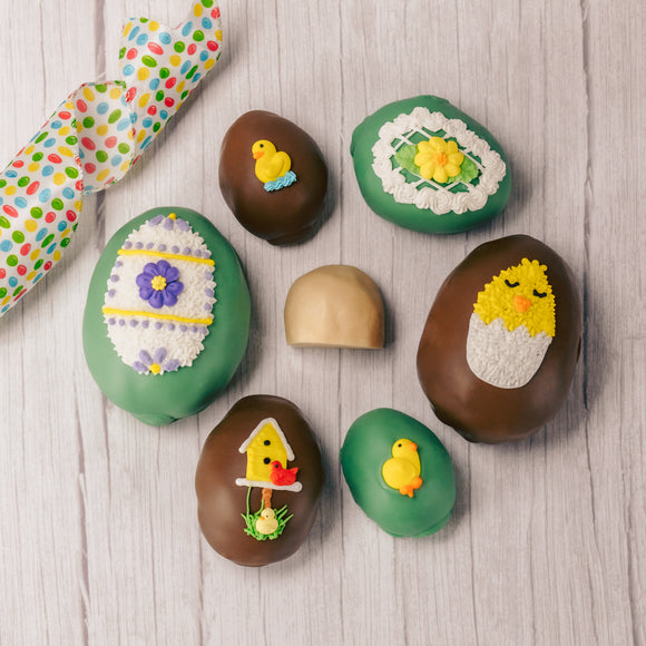 Butter cream and cream fondant center formed in egg shape covered in milk chocolate or green coating in various sizes.