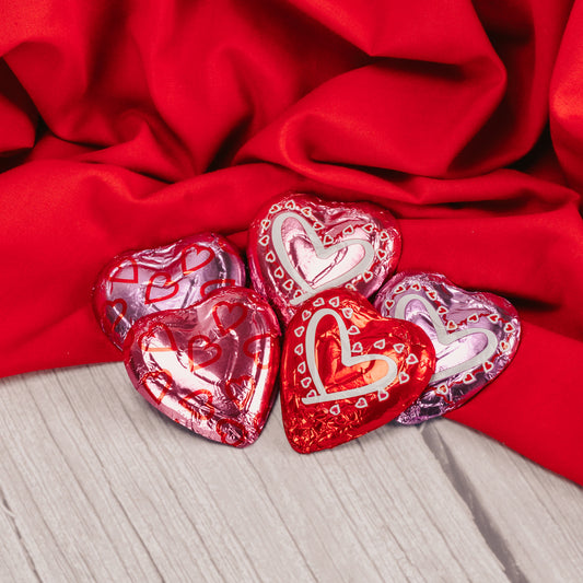 medium sized milk chocolate heart wrapped in red and pink foil.