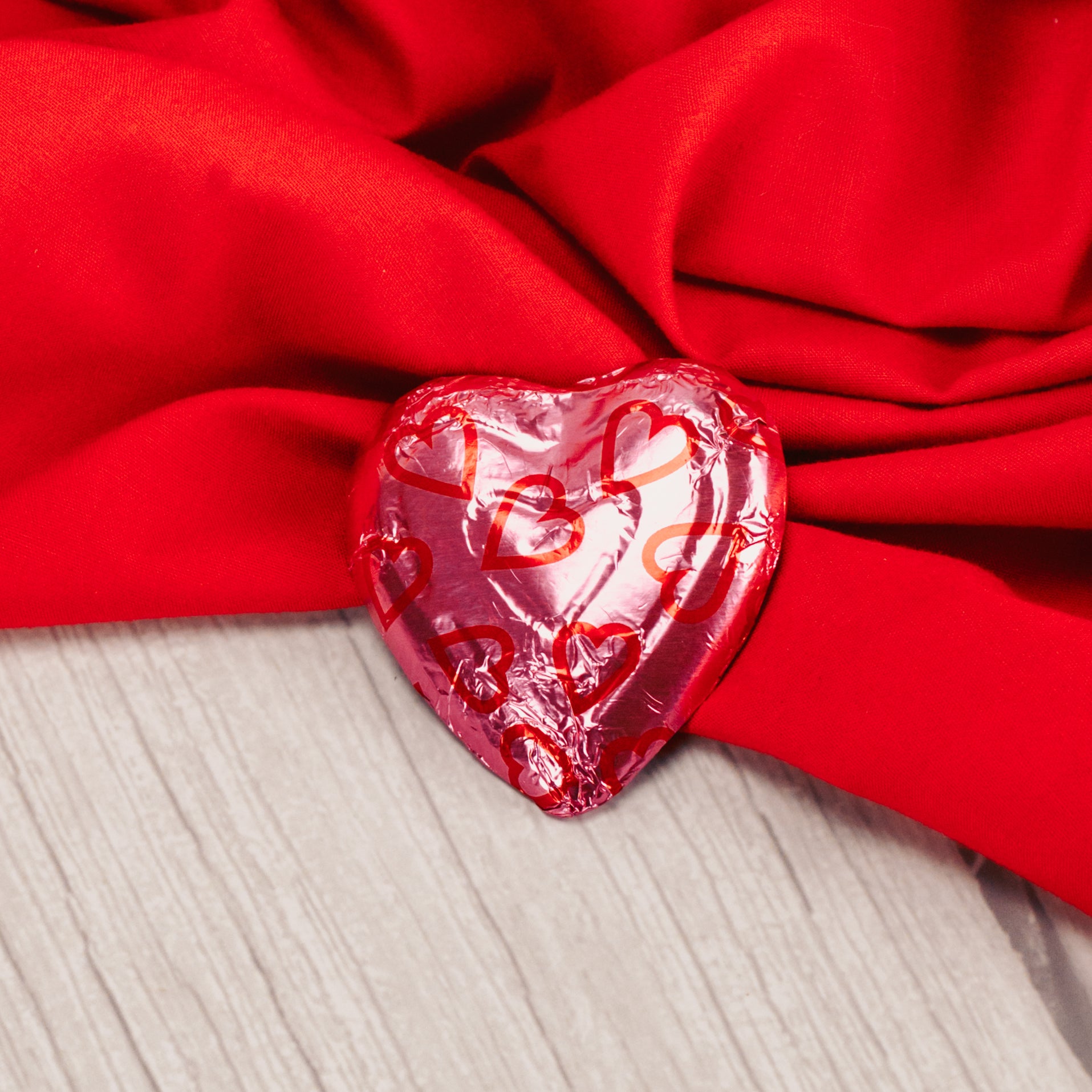 medium sized milk chocolate heart wrapped in red and pink foil.
