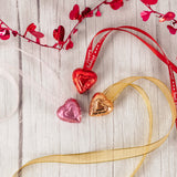 2 foil chocolate hearts together on festive ribbon makes a lovely necklace to wear for the holiday! Available in milk chocolate or dark