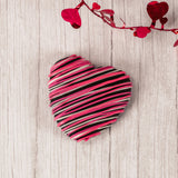 a wonderful marshmallow heart treat dipped in rich dark chocolate and drizzled with pink and white icing.