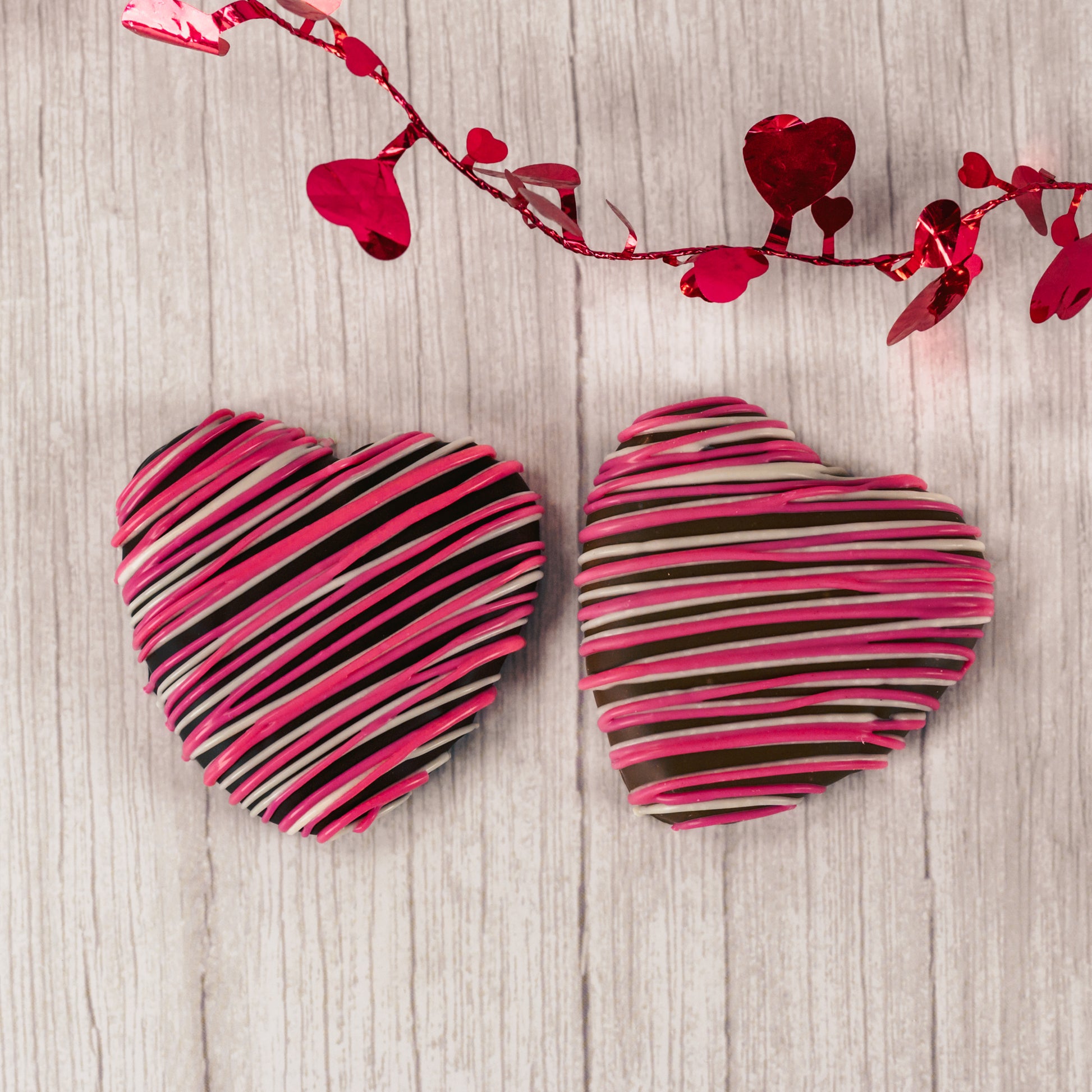 a wonderful marshmallow heart treat dipped in smooth milk chocolate or rich dark chocolate and drizzled with pink and white icing.