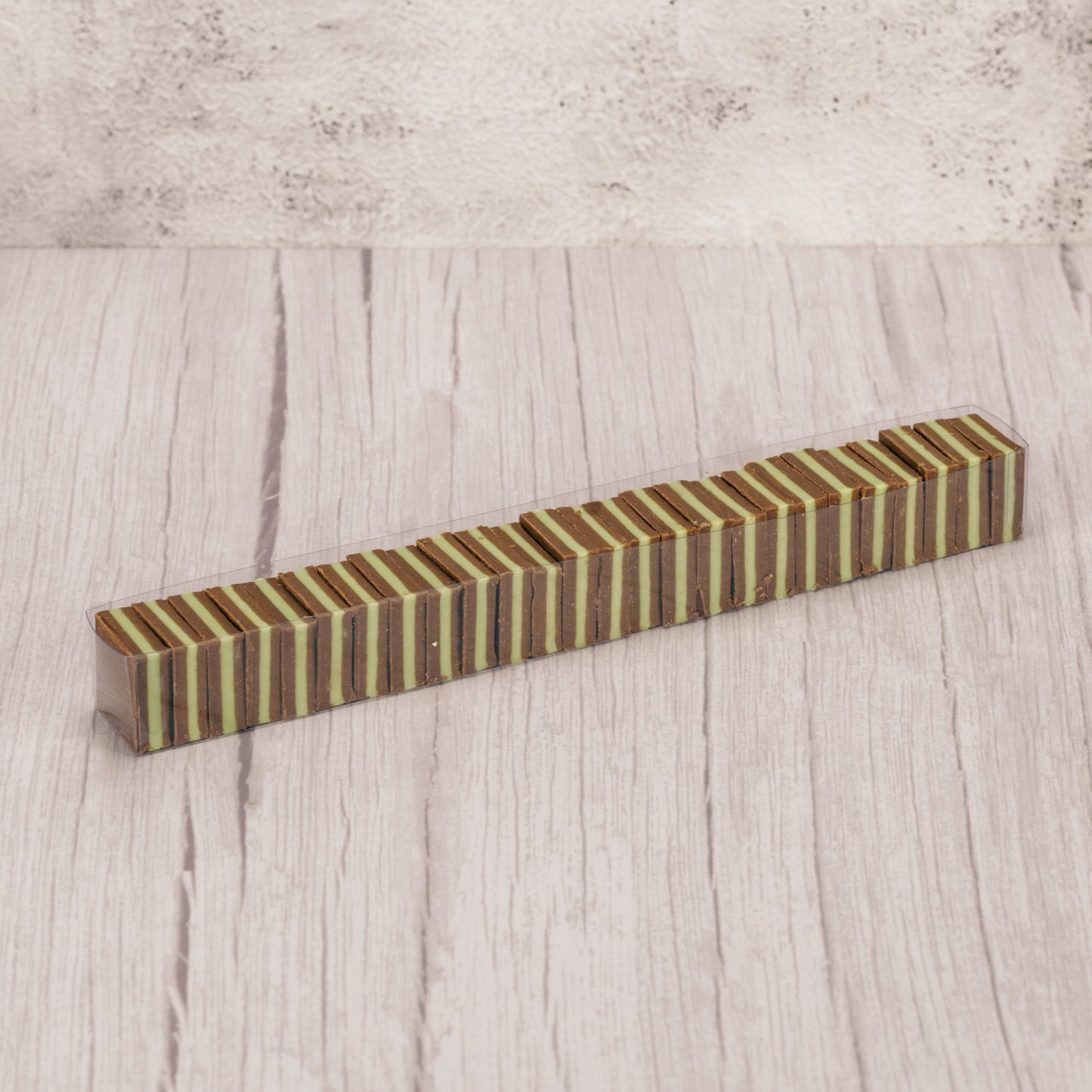 Silky milk chocolate with green mint layered and packaged in a half pound clear rectangle tubes.