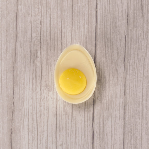 white coating with a dollop of yellow coating in the center to look like a real deviled egg!