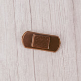Milk chocolate in the shape of a bandage.