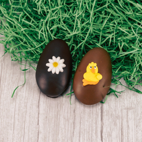 A bite- sized fluffy marshmallow center with a dollop of caramel egg is covered in smooth milk chocolate or rich dark chocolate and topped with an Easter sugar decoration.