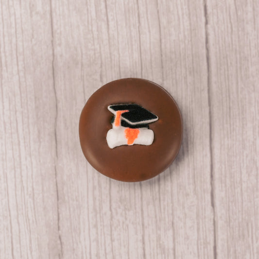 milk chocolate covered Oreo with a sugar grad cap and scroll decoration on top