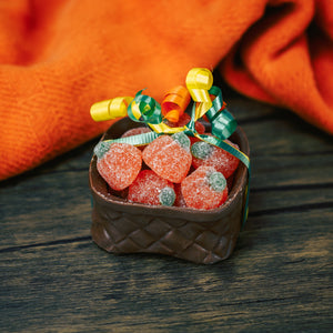 chocolate basket filled with gummi orange pumpkins