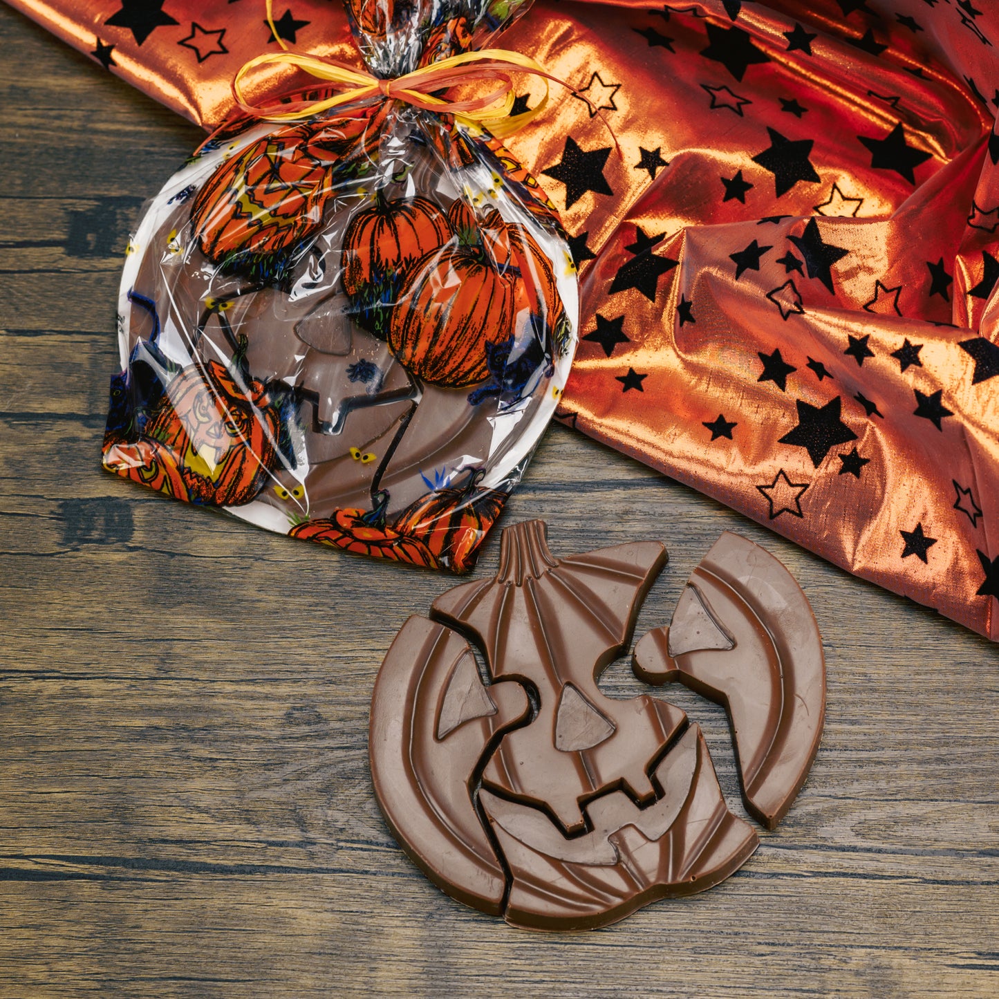 Milk chocolate pumpkin jack-o-lantern puzzle pieces. A total of four pieces.