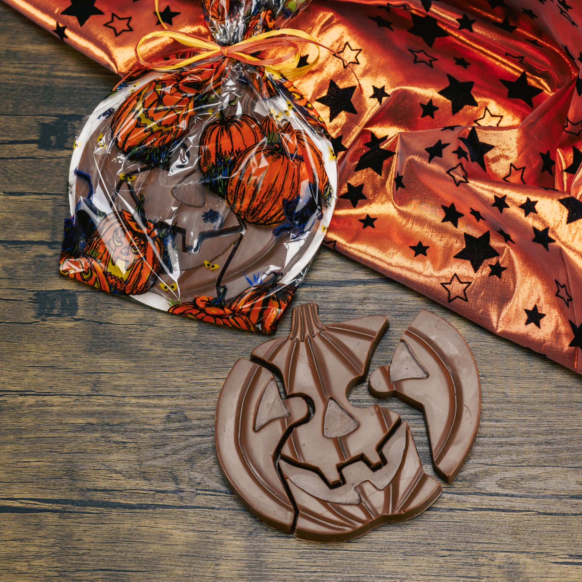 Milk chocolate pumpkin jack-o-lantern puzzle pieces. A total of four pieces.