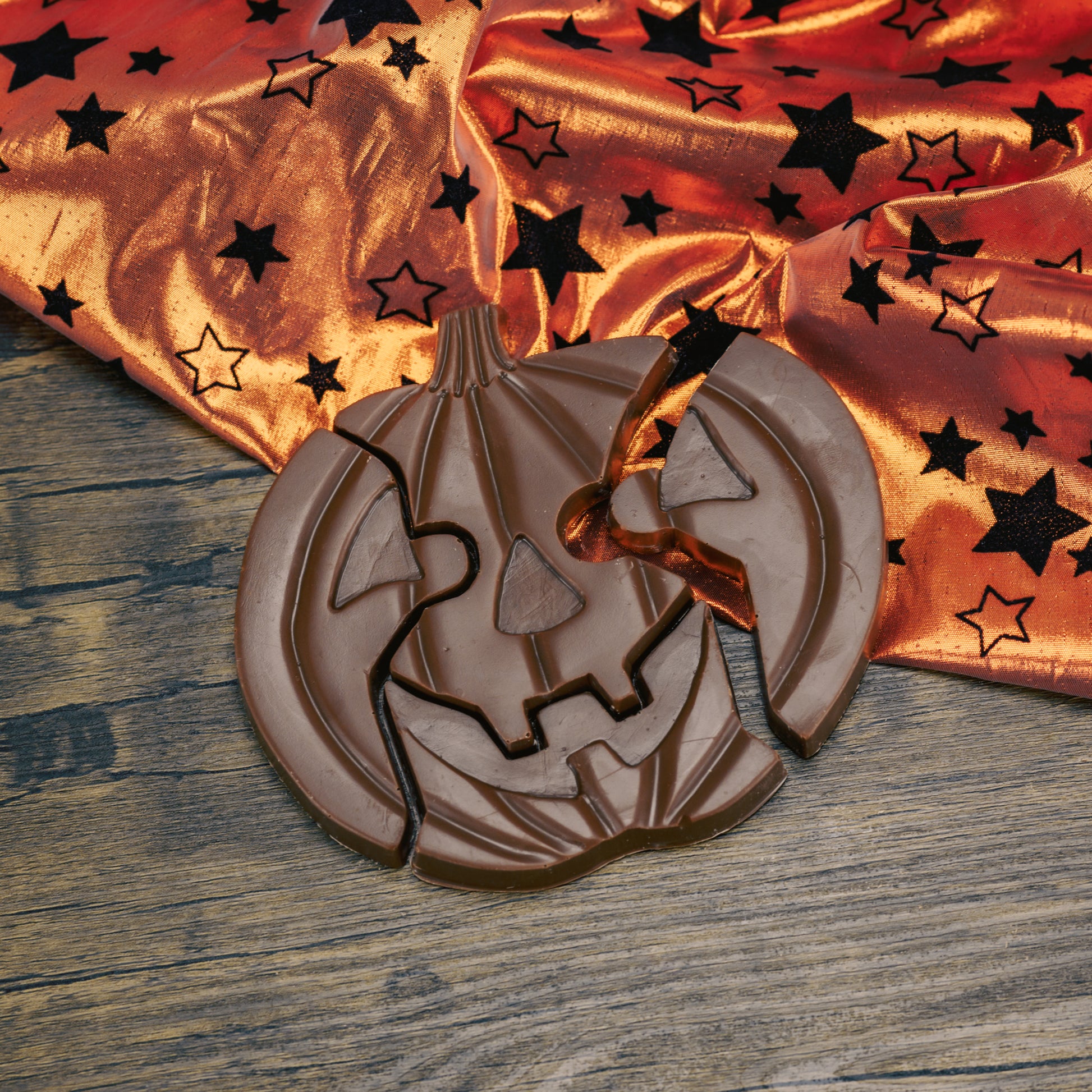 Milk chocolate pumpkin jack-o-lantern puzzle pieces. A total of four pieces.