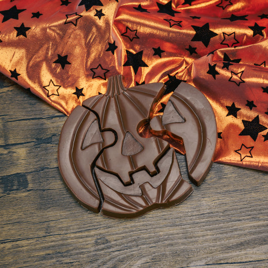 Milk chocolate pumpkin jack-o-lantern puzzle pieces. A total of four pieces.