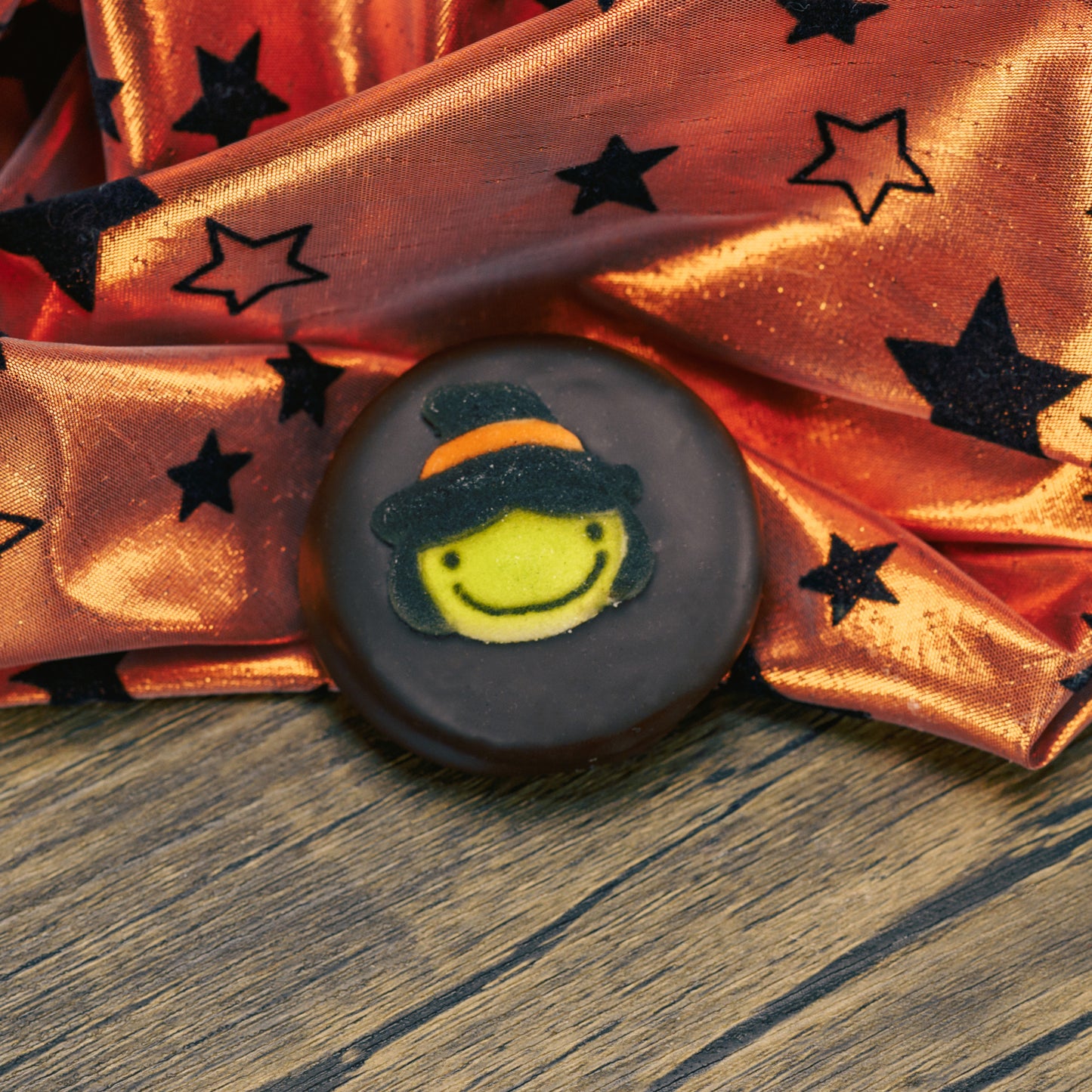 Oreo cookies covered in dark chocolate. Each with a sugar Halloween decoration on top.